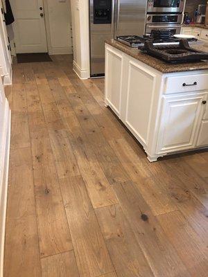 Oil finished wood flooring next to white cabinets is a beautiful contrast.