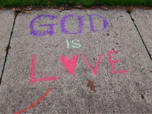 "GOD IS LOVE," written on NCF's sidewalk in chalk on Sunday, April 24, 2022.