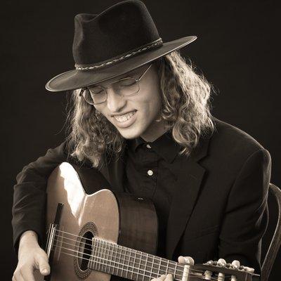 High school senior portrait, in studio with guitar.