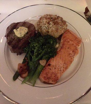 Main course of Filet Mignon and Steelhead Salmon, accompanied by Potato Au Gratin and broccollini.