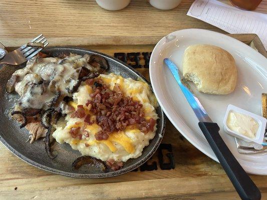 Smothered chicken and loaded mashed potatoes.