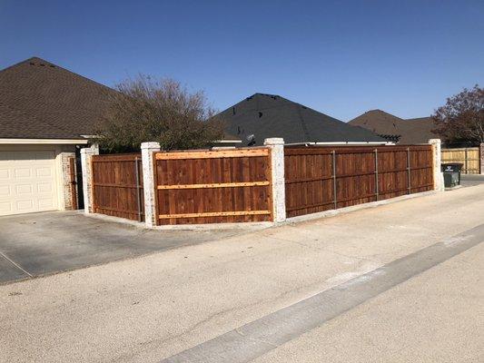 Fence install with cement pillars.