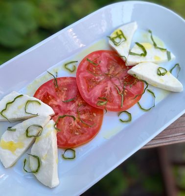 Fresh mozzarella, tomato, olive oil + basil (July 2022 menu)