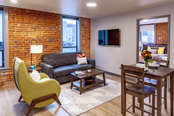 Living area and dining room table at Riverfront Park Travel Apartments