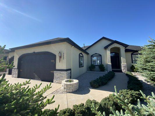 Exterior home painting over stucco and deck staining.