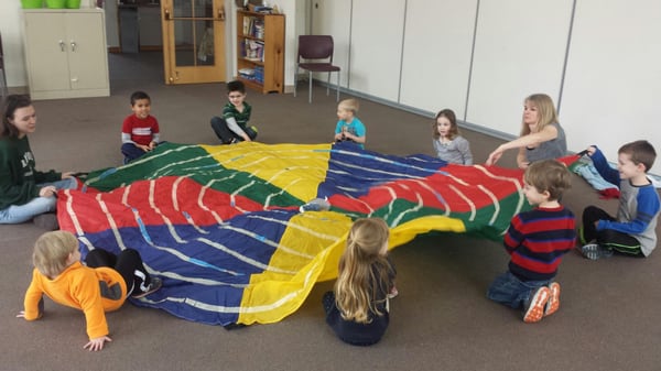 Ms. Lori leading students in great parachute fun!