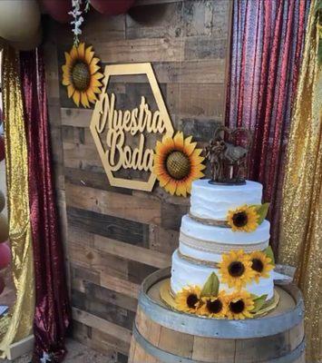 Photo backdrop and wine barrel for cake display