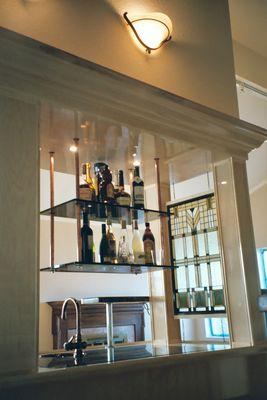 A bar with glass shelves.
Maple, glass, copper, stained glass