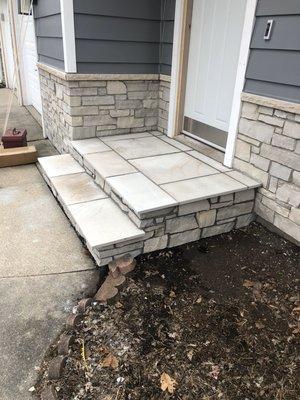 Installation of stone on house and steps