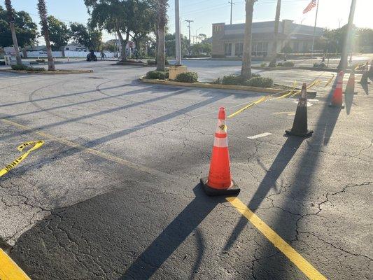 Painting the parking lot in front of the two restaurants that are open on a Sunday