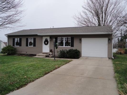 after photo, showing new roof, new siding, new gutters, new shutters