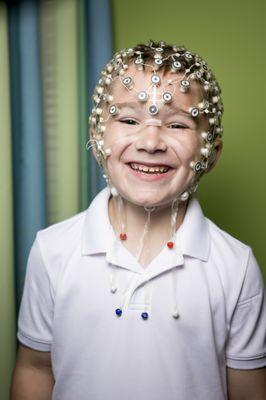 The Brain Lab uses a cap with small sponges to get a measure of brain waves while the kids look at different pictures and answer questions.