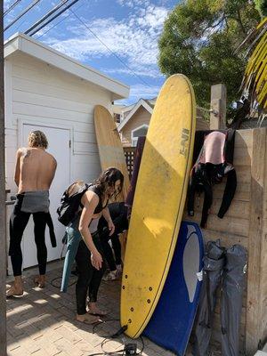 Nikki giving us access to the hotel's wetsuits and boards.