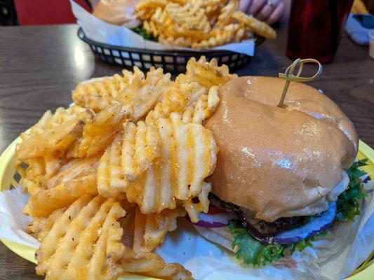 Cheeseburger with lettuce, onion, and tomato with fries