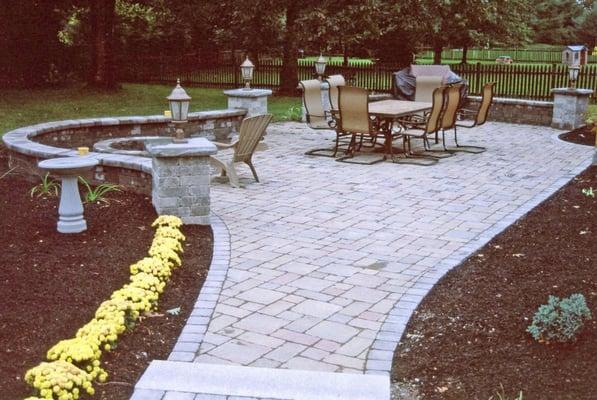 Backyard patio, stonewall with lighting and sitting area.