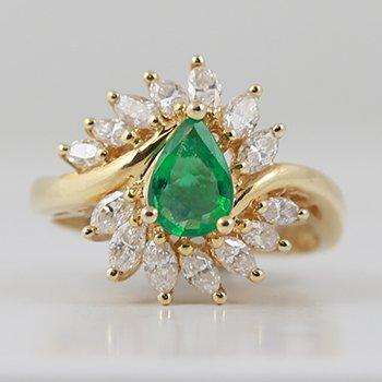 Lady's 14k yellow gold ring with emerald and diamonds.