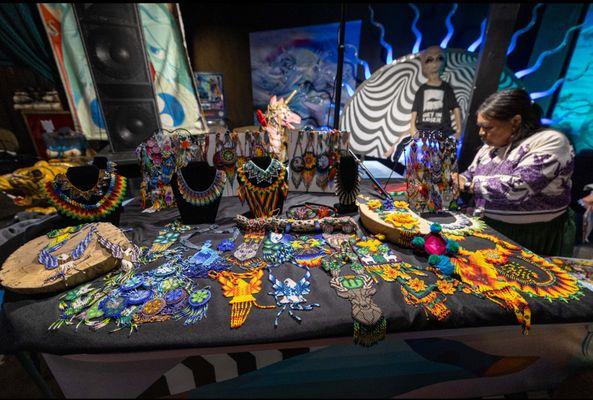 Wixárika elder Lupita selling her handmade beaded jewelry.