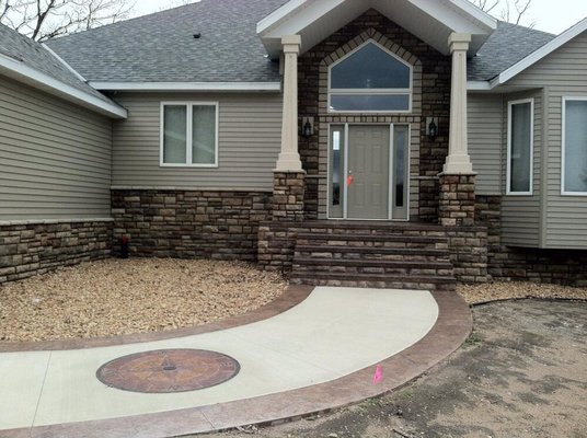 Custom stucco pillars, stone and sidewalks