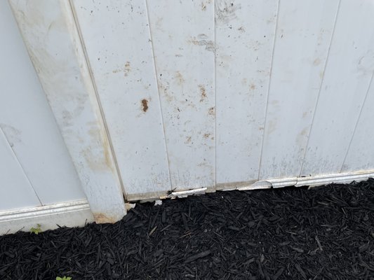 Broken and stained fence, along with broken pet fence and sprinkler system