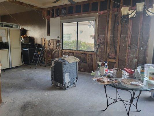 Floors ripped up and nonfunctional in  center of kitchen.