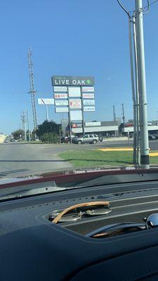 About to enter shopping center from 1604 frontage, passing Pat Booker Road