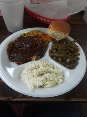 Delicious hamburger steak with green beans,  coleslaw,  broccoli casserole and roll.