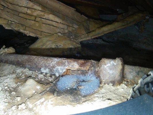 Cracked sewer pipe under in the crawlspace under the home