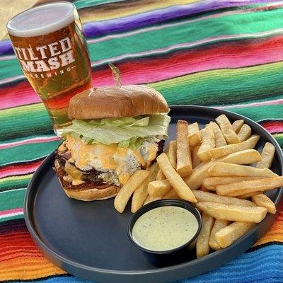 Muchacho Burger w/ fries next to a Muchacho Beer