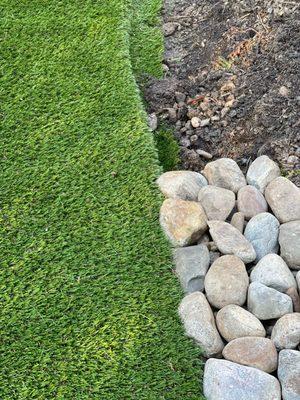 Artificial Turf makes a stunning liner to this rock garden.