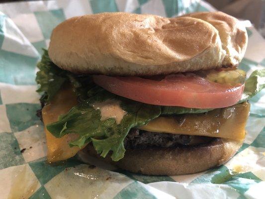 Single burger with cheddar, signature sauce, lettuce, tomato, pickles, grilled onions and grilled jalapeños. So good!