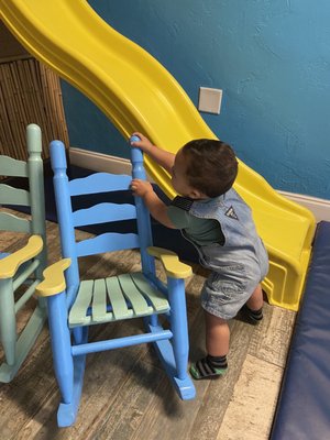 They have chairs for kids, a play mat, and a slide. My baby boy loved everything about this place.