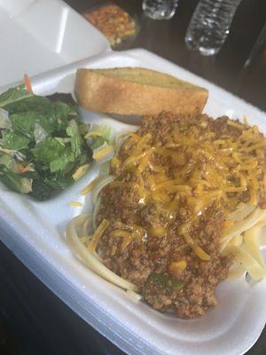 Baked spaghetti with garlic bread and Cesar salad