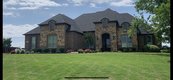 Trimmed bushes and mulch put down on this yard.