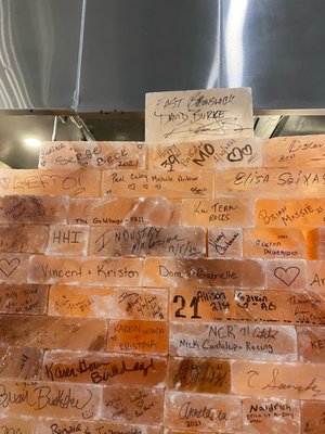 Signatures on Pink Salt Bricks from patrons dining at Orchard Park. David Burke's is on top