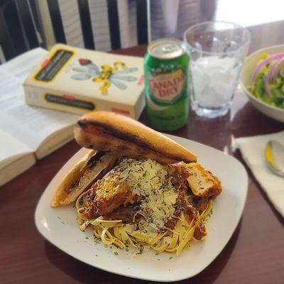 UNKOMMON CHICKEN Parmesan over FETTUCCINE  WITH THE RICHEST  8hr Pomodoro (red sauce)
Garlic bread and a salad