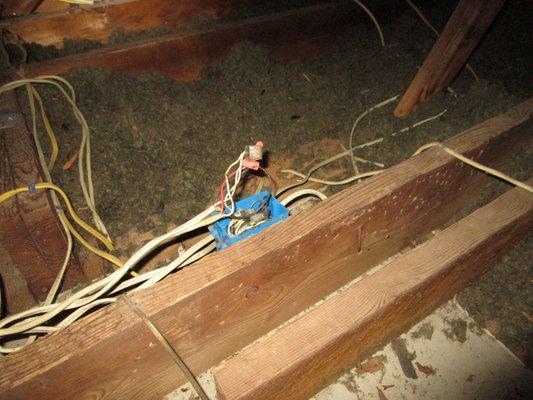 Open junction box as well as lack of insulation within attic.