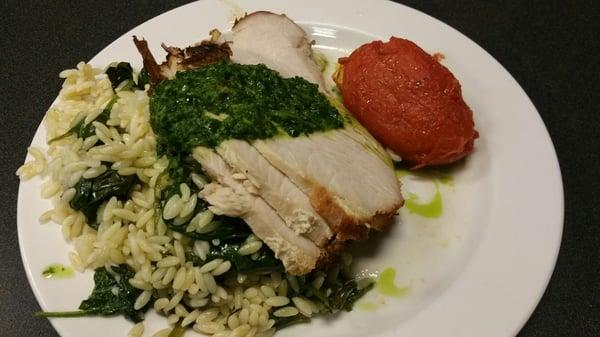 chimichurri topped Roasted Turkey Breast  and spinach orzo with a side of roasted romantic tomatoe