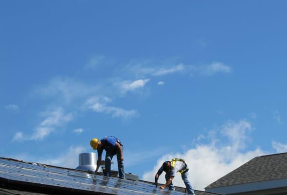 Renewable Rochester installing a solar panel system on a local business.