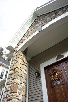 Custom beaded soffit with stone veneer with custom entry door.