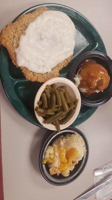 Chicken-fried steak, green beans, mashed potatoes, and peach cobbler.