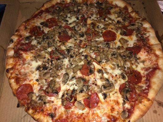 A large Sausage, Pepperoni, & Fresh Mushrooms pizza