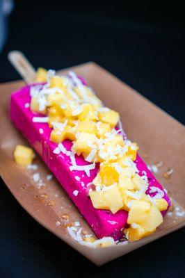 Pitaya pop with fresh mango topping and shredded coconut.