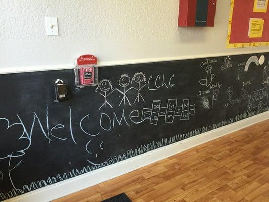 Our preschoolers having fun on our chalkboard wall.