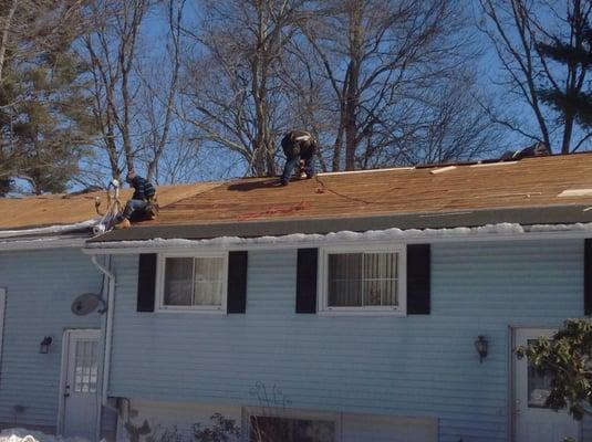 This is our team at work replacing rotten wood decking and installing Ice & Water Shield around the perimeter of the roof!