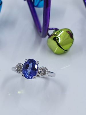 Oval Tanzanite set in 14k white gold ring with two round diamonds