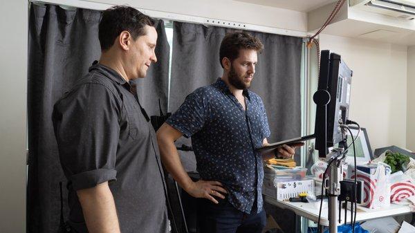 Director and 1st AD watching  shots on the monitor.