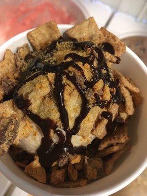 This is Cinnamon Roll Ice Cream with Cinnamon Toast Crunch, chocolate syrup, and butterfingers