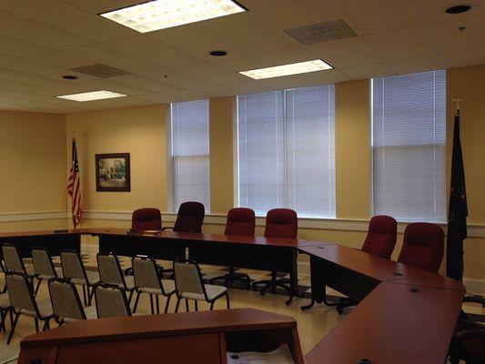 Ceiling speakers, boundary microphones and electric screen and  ceiling mounted projector. North Wales municipal building