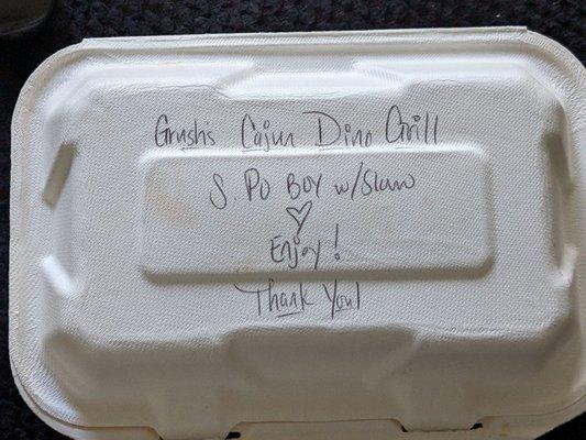 Handwritten note and cardboard recycling container.