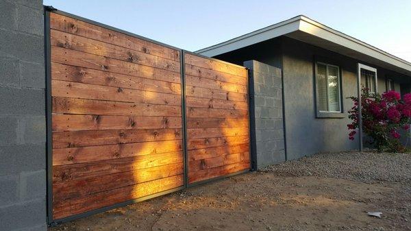 Custom made modern horizontal slat RV gate with Mahogany staining and dark grey frame.